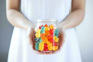 AI Generative. Jar with chewable gummy vitamins in children's hands photo