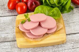 Slices boiled sausages for breakfast photo