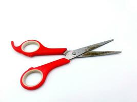 Old rusty red scissors isolated on white background. Used tool or Object concept. photo