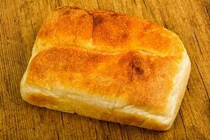 Homemade bread over wooden background photo