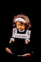 a doll with a black dress and white bonnet photo