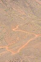an aerial view of a dirt road in the desert photo
