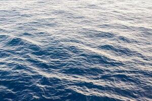 the ocean surface is blue and has ripples photo