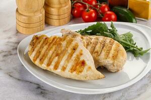 Grilled chicken breast served arugula photo