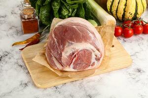 Uncooked raw pork knuckle with spices photo