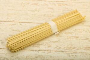 Udon noodles over wooden background photo