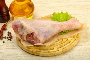 Turkey leg over wooden background photo