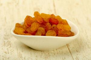 Raisin heap over wooden background photo