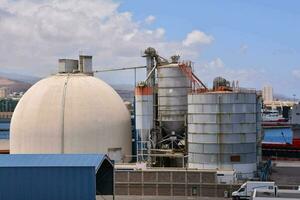 a large industrial plant with a large tank photo