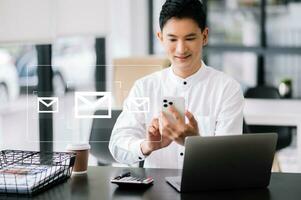 Man hands using Laptop, tablet typing on keyboard and surfing the internet with email icon, email marketing concept, photo