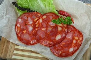 Chorizo sausage over wooden background photo