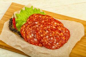 Chorizo sausage over wooden background photo