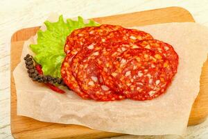 Chorizo sausage over wooden background photo