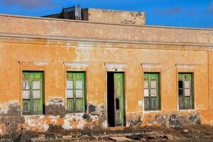 an old building with green windows photo