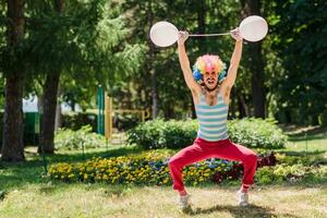 Mime performs in the park with balloons. Clown shows pantomime on the street. photo