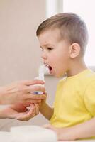 mother treats bronchitis in a child with a nebulizer photo