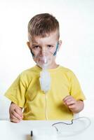 small child treats bronchitis inhaler at home photo