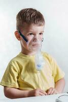 small child treats bronchitis inhaler at home photo