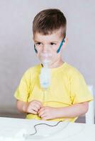 small child treats bronchitis inhaler at home photo