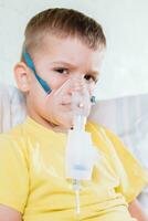 small child treats bronchitis inhaler at home photo