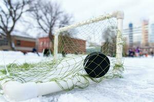 goal scored by a hockey puck in the goal net photo