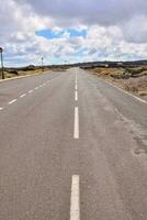 an empty road and a cloudy sky photo