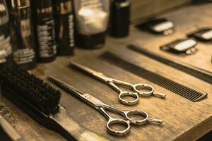 professional scissors and combs lie on a shelf in a hairdresser photo