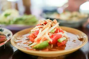 tailandés verde papaya ensalada, cuales es además conocido como som tam es uno de el más comúnmente disponible y más generalmente consumado platos en todas de tailandia foto