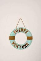 a life preserver that says fuerta ventura hanging on a wall photo
