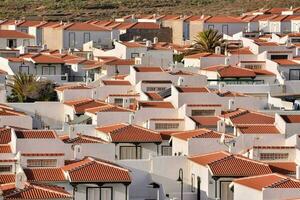 a row of white houses with red tiled roofs photo