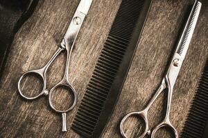 combs and scissors for haircuts lie on a shelf in the cabin photo