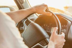 A man driving a car on a Sunny day photo