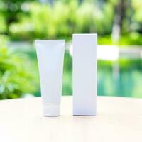 White long tubes have a front and back view surrounded by left outside on a sunny day with blur nature green background. Suitable for product samples or demo images for advertisement. Clipping Path. photo