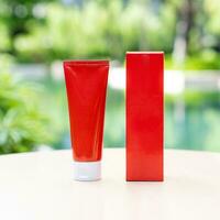 RED long tubes have a front and back view surrounded by left outside on a sunny day with blur nature green background. Suitable for product samples or demo images for advertisement. Clipping Path. photo