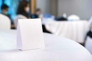 Triangular shaped table sign is placed on the table for scanning QR codes as an announcement, reservation sign, or menu at the seminar. photo