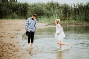 Beautiful just married have fun and rejoice on the coastline. photo