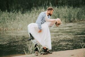 Beautiful just married passionately embrace on the coastline. photo