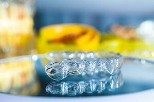 Invisible aligners teeth retainers lie on the mirror photo