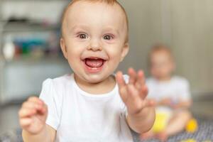 Happy child laughing while sitting on the floor photo