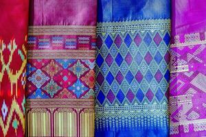 colorful silk saris in a shop in thailand photo