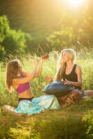 Young women play and sing on the musical instrument Handpan. Practice meditation at sunset photo