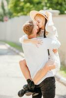 Loving and happy couple kissing outdoors in summer photo