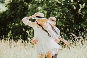Happy and laughing couple having fun and spending time together on a sunny day in summer photo