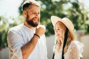 Very happy couple laughing outdoors in summer on a sunny day photo