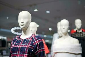 hembra maniquíes son vestido en casual ropa con un naranja roja tema en Moda tienda a el Departamento almacenar. foto