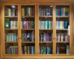 Blur vintage wooden shelf library for education background. photo