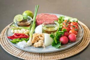 Spicy Thai salad style, are arranged and placed on a local tray set. photo