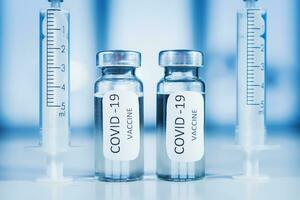 COVID-19 coronavirus vaccine. Ampoule and syringe close-up. Concept photo