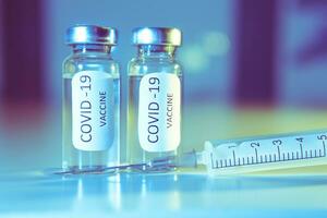 COVID-19 coronavirus vaccine. Ampoule and syringe close-up. Concept photo