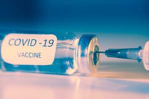 Vaccination against coronavirus COVID-19. Ampoule and syringe close-up. Concept photo